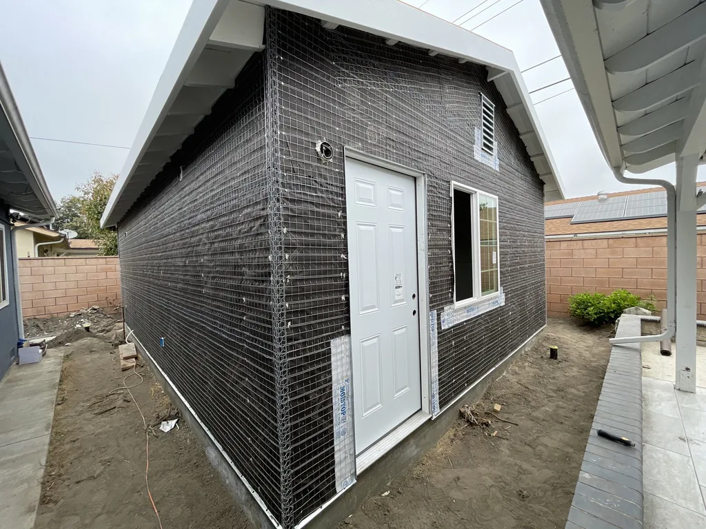 Wire lath and building paper wrapped around a detached accessory dwelling unit before stucco